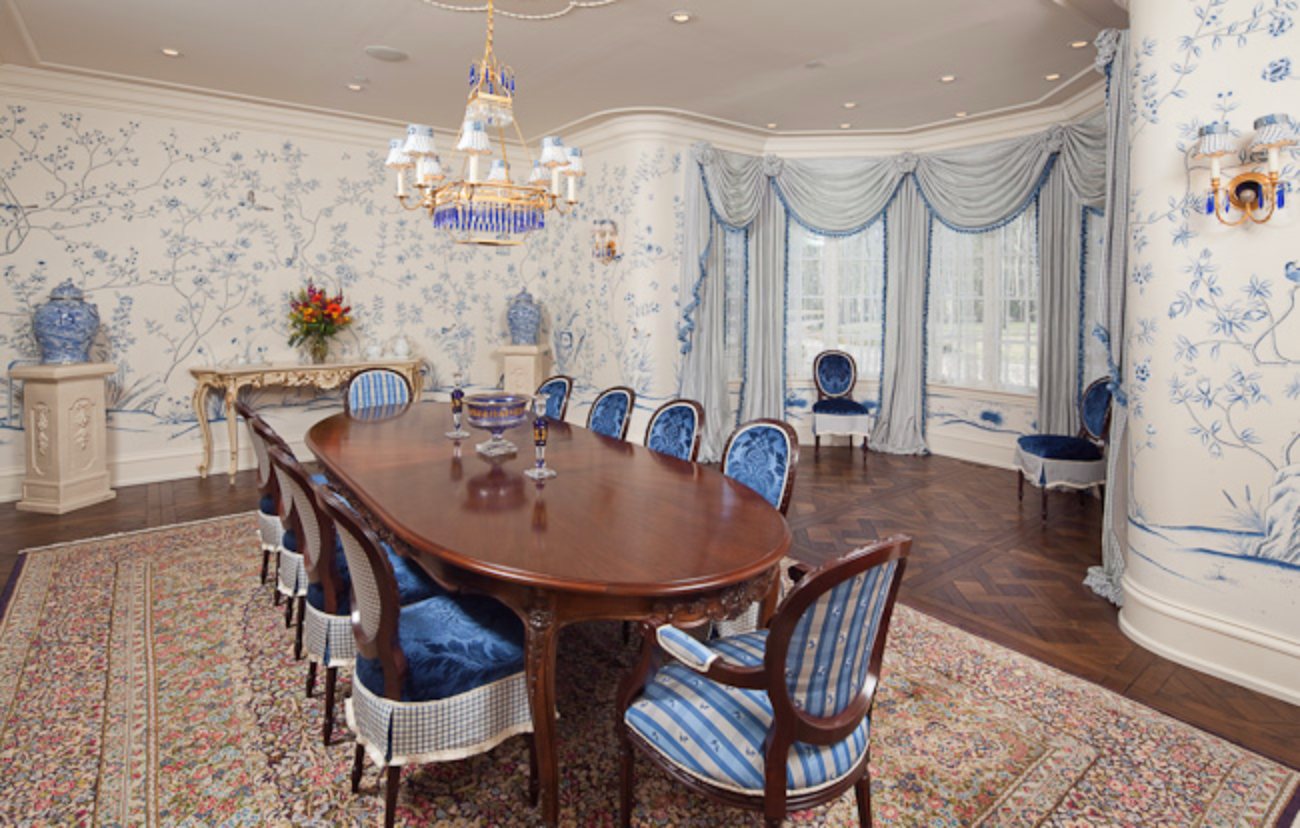 Formal dining room wrapped in a blue and white hand-painted chinoiserie mural on silk