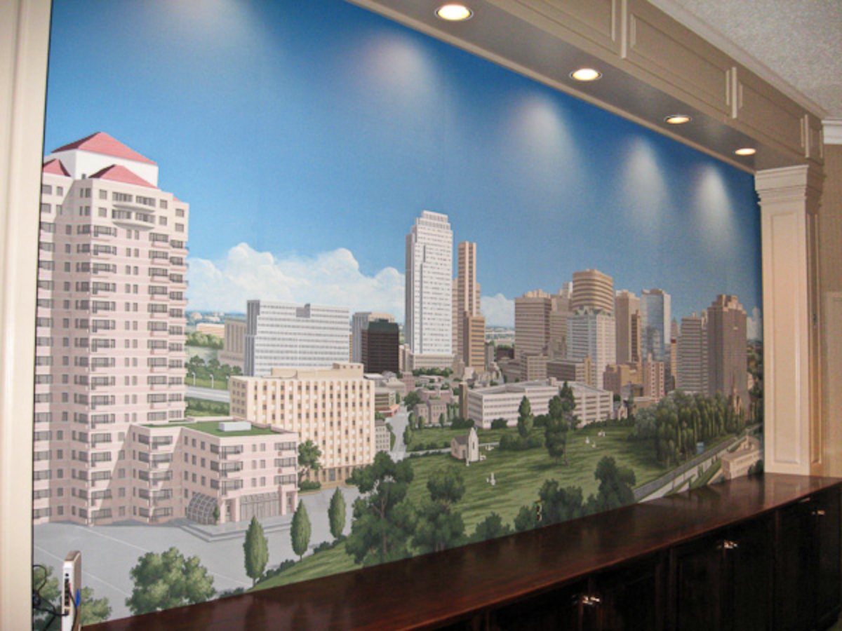 Large custom painted city skyline mural above a built-in cabinet